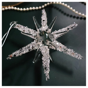 Macro shot of glass star ornament with beaded texture and elegant pearl necklace decor