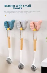 Adjustable thumb shaped mop holders in blue, grey, and pink on a marble wall