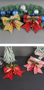 Detail of Christmas bows with gold glitter, pine cones and red berries for festive decor