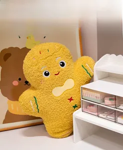 Detailed view of yellow plush gingerbread man pillow with soft fleece and cute embroidery
