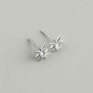 Detail of S925 silver star stud earrings with sparkling cubic zirconia center stones