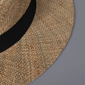 Handwoven flat top seagrass sun hat with black grosgrain ribbon for summer beach vacations