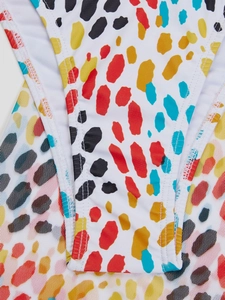 Close-up of colorful polka dot print and double-needle stitching on bikini fabric