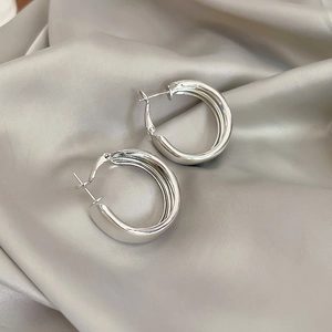 Minimalist wide thick silver hoop earrings with polished mirror finish on silk cloth