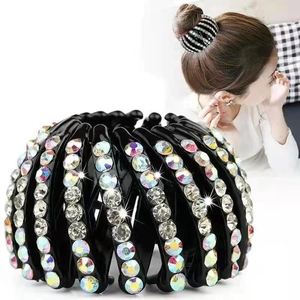 Detail of expandable black velvet bird nest hair clip with sparkling colorful rhinestones