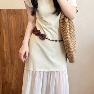 Floral chiffon waist chain with brown wood beads and acrylic accents on a light dress
