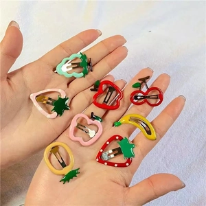 Set of 8 colorful cartoon fruit snap hair clips for girls in a hand-held display