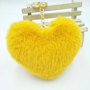 Fluffy yellow heart-shaped faux fur keychain with gold-tone link chain and clip