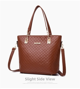 Detail view of brown quilted tote bag with gold chain strap and adjustable leather shoulder strap