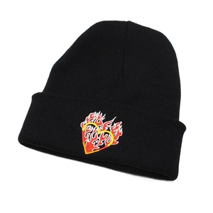 Close-up of black knitted beanie featuring detailed red flame heart embroidery design