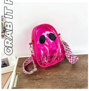 Detail of rose red transparent PVC jelly bag featuring a quirky ghost face design