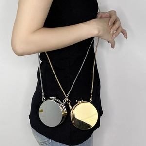 Mini acrylic round bag with metallic finish and delicate chain straps in gold and silver