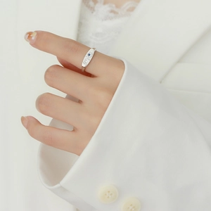 Elegant sterling silver eight-pointed star open ring with blue and white gemstones on finger