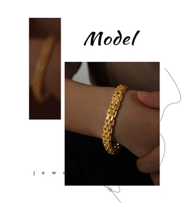 Detail of vintage-style gold-plated titanium steel watch strap chain bracelet on wrist