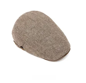 Top view of brown herringbone flat cap with detailed vintage British wool texture