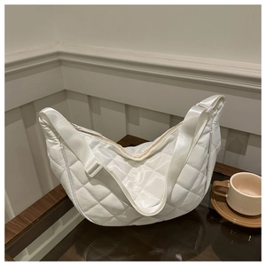White quilted crescent crossbody bag with silky finish and adjustable strap