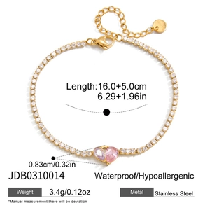 Detailed view of gold stainless steel tennis bracelet with pink heart-shaped zircons