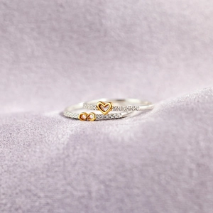 S925 silver infinity heart rings set with cubic zirconia on purple fabric background