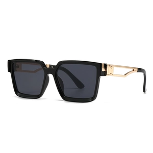 Fashionable square black sunglasses with luxury hollow gold metal temples on white background