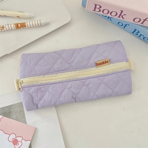 Close-up of a quilted lavender pencil case with zip closure and soft fabric texture