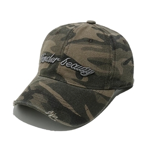 Detail of camouflage baseball cap with Super Beauty embroidery and distressed brim edge