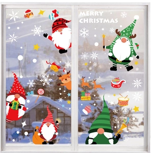 Detail of Christmas window stickers with Santa and reindeer on white frame in winter scene