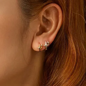 S925 sterling silver star hoop earrings in gold and silver finish on female model