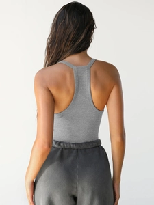 Detail of ribbed knit racerback top and elastic waist jogger pants on model back