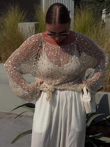 Sequin hollow knit sweater featuring round neck long sleeves and stylish front knot detail