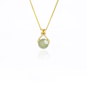 Minimalist gold necklace with a green jade pendant and zircon accents on white background