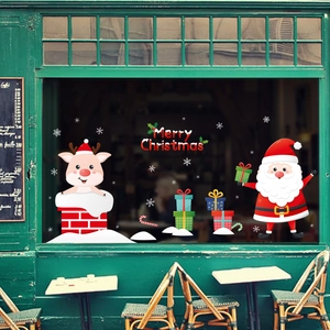 Detailed view of Santa and reindeer window sticker on glass with Merry Christmas text