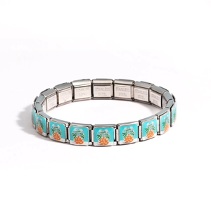 Detailed macro view of silver stainless steel link bracelet with blue enamel pineapple charm