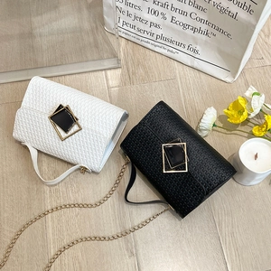 Fashionable woven mini crossbody bags in black and white with gold chain straps