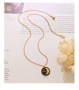 Detail of 18K gold star and moon pendant necklace with K18 hallmark on the clasp