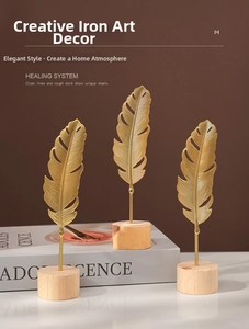 Three-piece golden iron feather sculptures with wooden bases for modern home decor