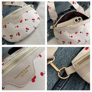Detailed views of white cherry print crossbody bag with gold zippers and wide strap