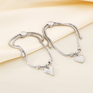 Detail view of heart-shaped pendant on silver snake chain with adjustable slider clasp