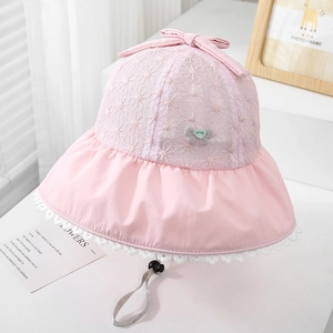 Close-up of pink sun hat featuring delicate hollow lace flowers and a sweet bow knot