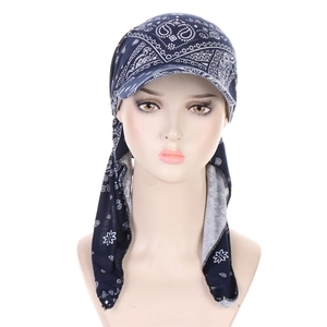 Detail of navy blue turban hat with white paisley pattern on soft fabric material