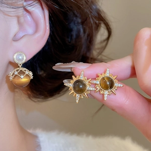Detailed close-up of vintage 18K gold plated tiger eye stone and pearl stud earrings
