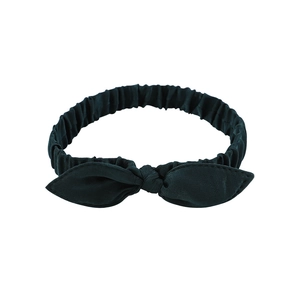 Close-up of dark green bow headband showing high-quality fabric texture and elastic band