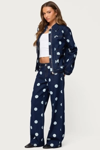 Detail of dark blue denim two-piece set with light blue polka dot pattern and wide-leg fit