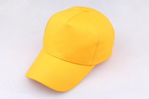 Detailed close-up of bright yellow cotton baseball cap showing fabric texture and stitching