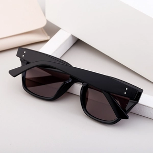Fashionable square black frame polarized sunglasses with high-quality dark lenses on a pedestal