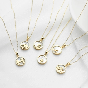 Golden stainless steel necklaces with shell pendants featuring sun and ocean motifs