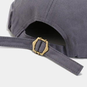 Close-up of adjustable metal buckle and dark gray cotton strap on back of brimless cap