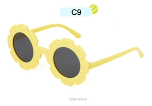 Side view of yellow sunflower shaped children sunglasses with dark round UV protection lenses