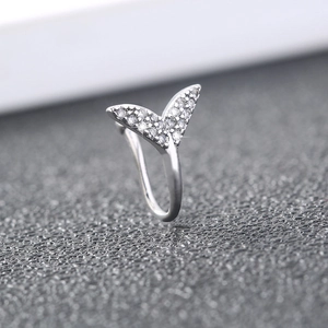Macro shot of silver whale tail ring detail with sparkling inlaid zircon stones