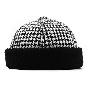 Classic houndstooth beanie hat with black faux shearling trim for autumn and winter
