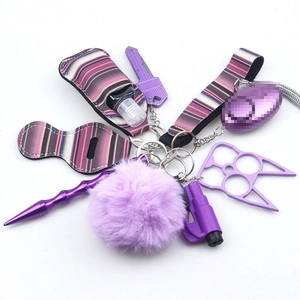 Detail view of purple self-defense keychain set including alarm and sanitizer holder